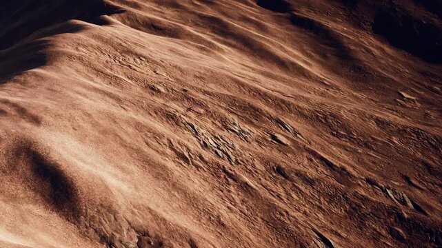 The scene captures a vast desert landscape during sunset. The sandy surfaces display various textures and patterns created by the wind over time. Shadows stretch across the terrain.