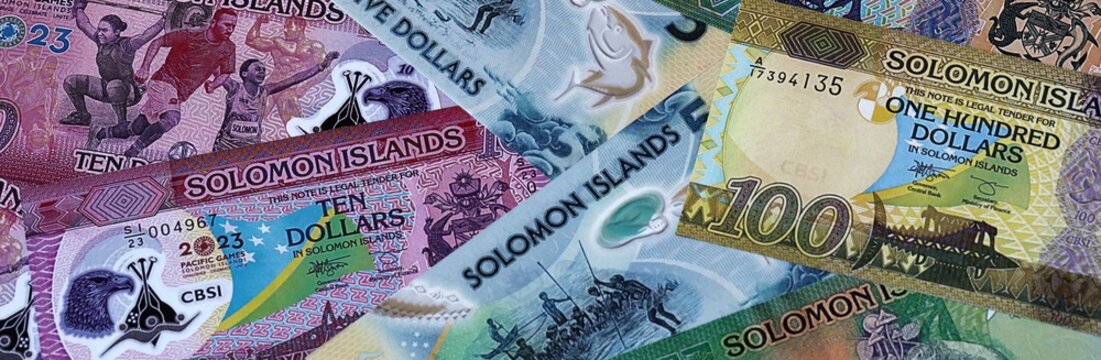 Solomon Islands dollar money bills in pile. Big amount of Solomon Islands SBD currency cash close up