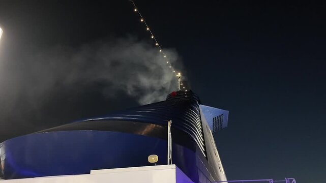 smoking ship emitting smoke at nighttime in a dark sky with a metallic structure and smoky exhaust viewed from a frontal perspective, industrial and atmospheric impact.