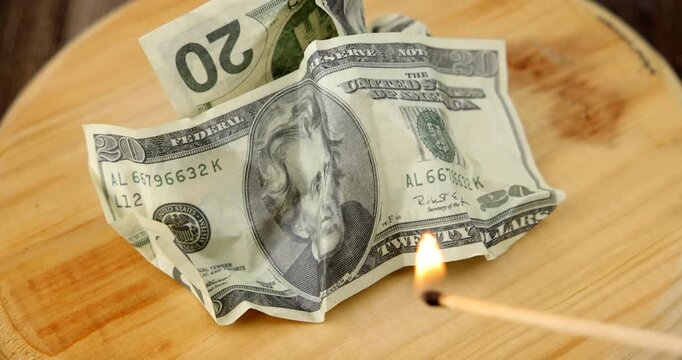 Beautiful layout of burning american twenty dollar currency notes rotating on vintage wooden platform over dark office background