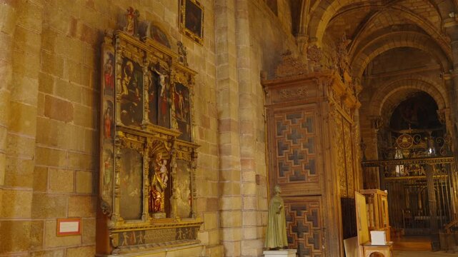 A camera slowly pans across an elaborately decorated side chapel with gilded altar and painted walls.