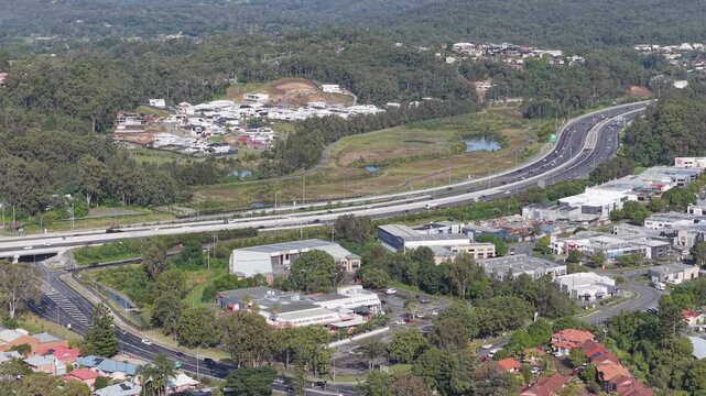 Aerial view panning to the left over the M1 Motorway, Palm Beach and Tallebudgera Creek on the Gold Coast, Queensland, Australia