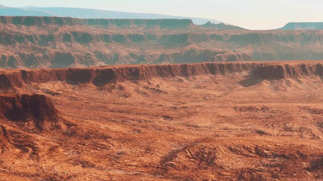 The scene shows a large desert area with multiple rocky levels and distant mountains under a fading light. The ground has shades of brown and orange, creating a rugged terrain.