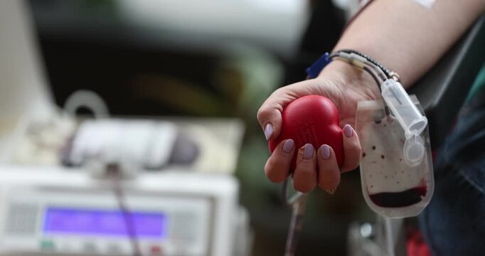 Blood donor hand detail during blood donation procedure
