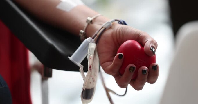 Blood donor hand detail during blood donation procedure
