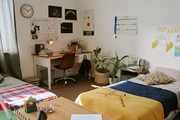 Fototapeten Musik Wide angle shot of teenager bedroom with study desk, school supplies, calendar, posters, beds, showing student organization, youth lifestyle. For education, dorm, parenting, back to school marketing  © AnnaStills