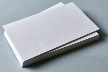 Fototapeta premium The Blank Business Cards Stack on a Soft Gray Background for Branding Mockup