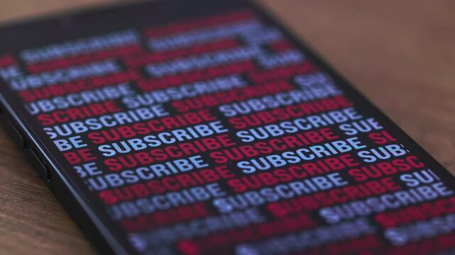 Smartphone screen, subscribe in red and white text appears. Subscribe or register to a video channel, social media account, online shop, website, internet blog, influencer account or newsletter. 