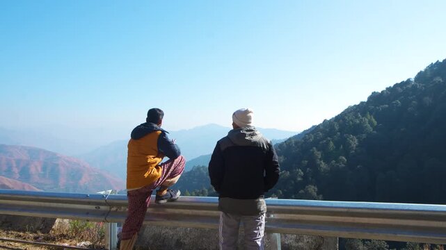 Two people enjoying scenic mountain view on a sunny day, peaceful outdoor setting, chakrata, dehradun, uttarakhand