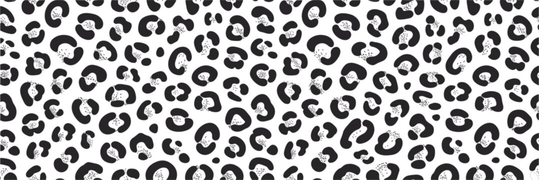 Seamless pattern featuring a black and white leopard print with organic spots for textile, fashion, and background use