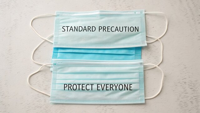 Three Medical Facemasks with Messages about Standard Precaution and Protecting Everyone in a Health Context