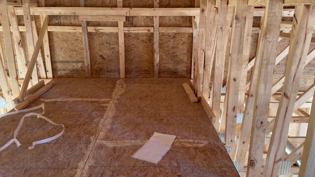 Static shot of an unfinished residential attic during the structural skeleton stage highlighting high-quality craftsmanship. Perfect for subcontractor inspection and property development projects.