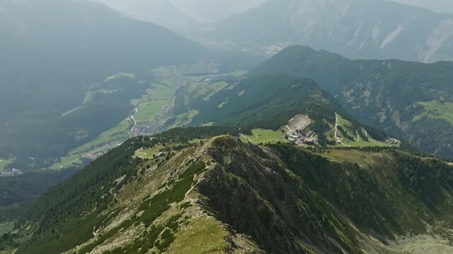 Aerial panorama of alpine mountain ranges in Tyrol Austria featuring rocky slopes untouched forests and magnificent scenery for European travel