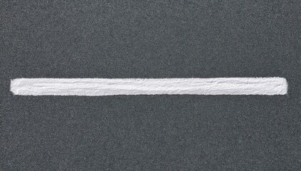 Fototapeta premium A stark white line bisects a textured dark gray background