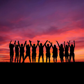Group of People Raising Hands Against a Vibrant Sunset Sky