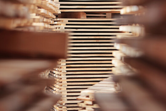 Wooden pallets. Wooden pallets for transportation of building materials. Environmentally friendly products. Pallets made of renewable wood. Out of focus.