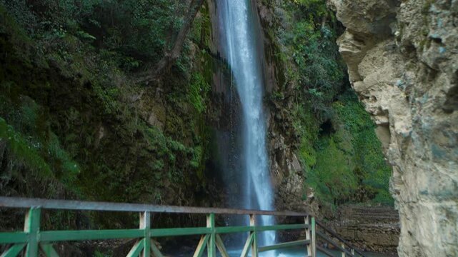 Water cascading down a lush forest cliff in Chakrata, Dehradun, Uttarakhand