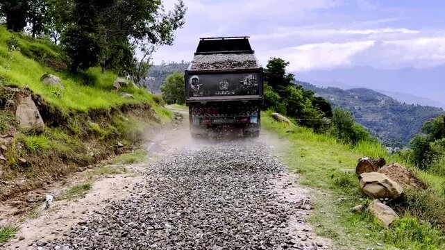Dump Truck Spreading Gravel on Under Construction Road for Highway Infrastructure Development, Civil Engineering and Road Building Project Progress