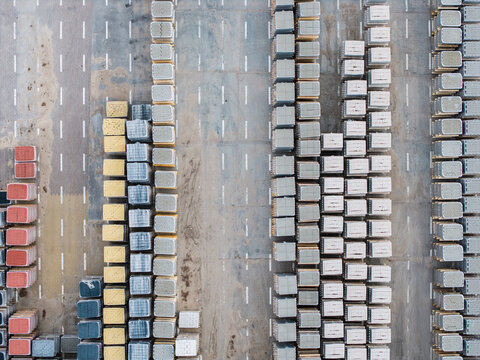 Aerial view of a paving stone factory with rows of colorful concrete blocks stacked in an industrial yard in Riga, Latvia.