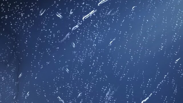 Dramatic lightning bolts striking through a heavy downpour during a dark storm at night with intense electrical flashes and rain streaks on a window pane