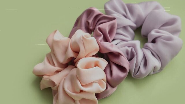 Trendy Silk Scrunchies animation. Trendy Silk Scrunchies Background. Set of Stylish Scrunchies on Color Background.