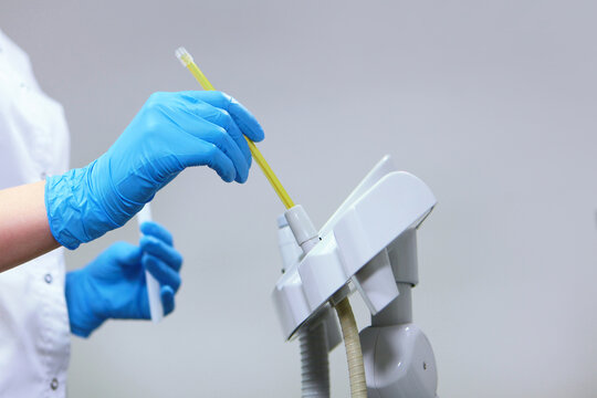 Disinfection and cleaning in the dental office. Disinfection of dental equipment. Patient safety in the clinic. The concept of cleanliness and health. Hands in protective gloves.