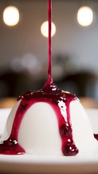 A dessert with sauce drizzling on top sitting on plate indoors