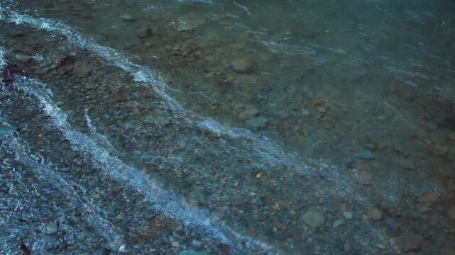 Clear water flowing over river pebbles in a serene mountain stream, Chakrata, Dehradun, Uttarakhand