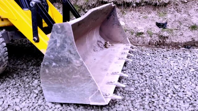 JCB Machine Leveling Gravel on Road Construction Site for Highway Infrastructure Development, Civil Engineering and Earthmoving Equipment Operations Progress