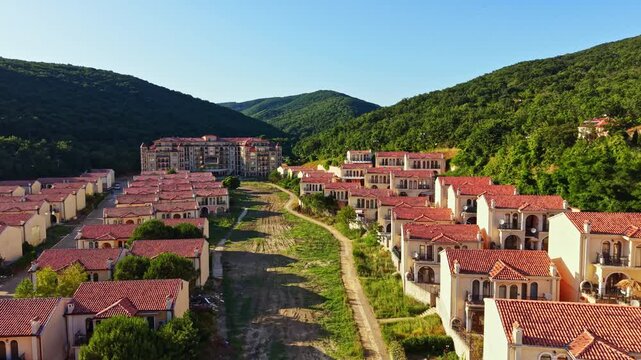 Elenite is shown after a flood, with buildings and homes impacted. The landscape is dry, and vegetation appears affected. The area is quiet with no visible activity.
