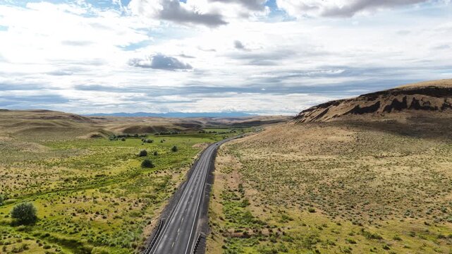 Aerial of WA State Route 17 in grassland and rolling hills near Leahy Washington with expansive dry steppe terrain and distant mountain ranges