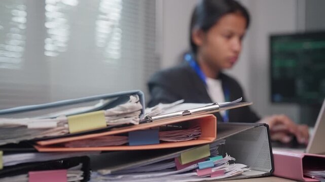 Business Documents and File Binders with Employee Working in Office