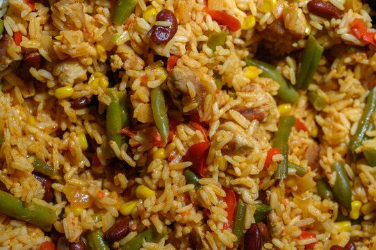 Savory rice dish featuring colorful vegetables and tender chicken cooked in vibrant spices