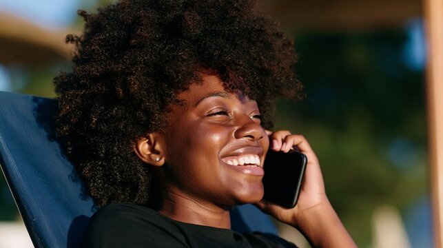 Joyful Woman Talking on Cell Phone, Outdoor Setting, Leisure Time, Relaxed Posture.