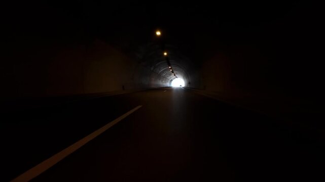Driving Through a Dark Modern Highway Tunnel with Lights, POV Video