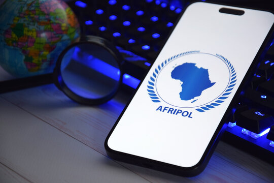 The smartphone with Interpol logo displayed on screen. International Criminal Police Organization or Interpol.
