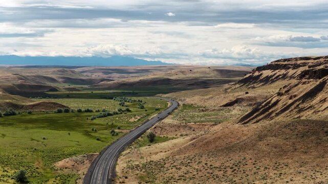 Aerial of WA State route 17 in rolling hills and valleys near Leahy Washington with paved road winding through the semiarid landscape