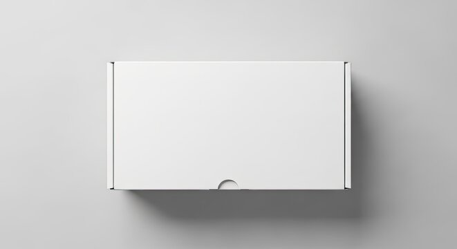 Blank white poster mockup hanging on a gray wall with wooden frame for displaying artwork, photos, or prints in a minimalist interior setting