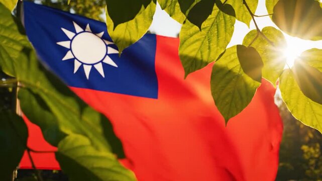 The flag of Taiwan waves behind green leaves in the sun