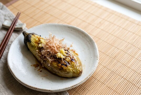 Close up of traditional Japanese grilled eggplant yaki nasu beautifully glossy with light soy sauce