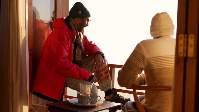 Two friends talking on a balcony with tea in Chakrata, Dehradun, Uttarakhand