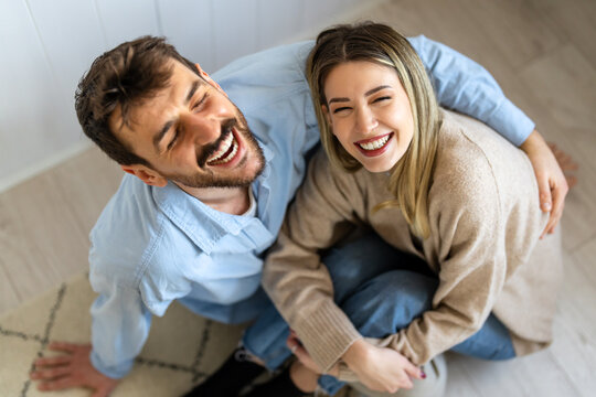 Young diverse couple moving in new home. Couple is having fun in new house at moving day