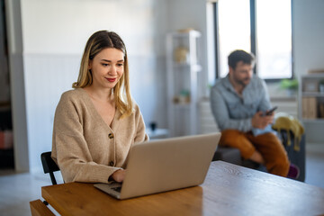 Fototapeta premium Woman working remotely from home office, having an online meeting, enjoying flexible freelance work