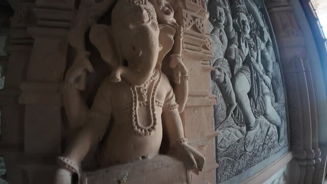 Detailed Stone Carving and Bas-Relief Sculpture of a Deity on an Ornate Temple Pillar at, Baba Mastnath Temple Rohtak, Haryana, India 