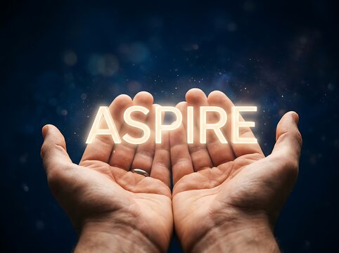 Hands holding glowing inspire word in dark background.
