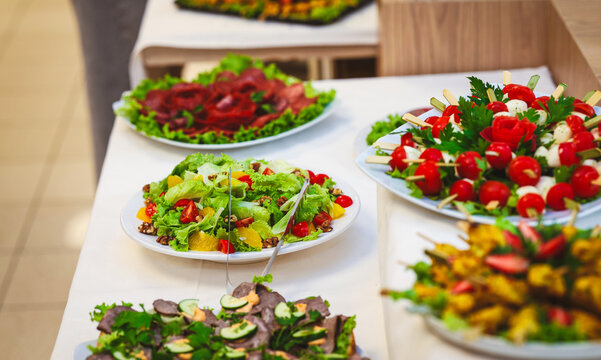 Fresh buffet table with salads, cold cuts and appetizers ready for guests. Authentic catering setup in a restaurant for hospitality, brunch and special events.