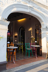 Arch with a colorful street cafe with tables © Tetiana