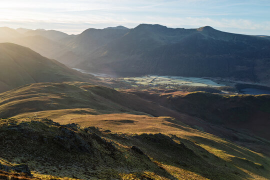 Views down towards Whiteless Breast and Rannerdale with the summits of High Crag, High Stile and Red Pike in the distance in the Lake District, Cumbria, England UK.