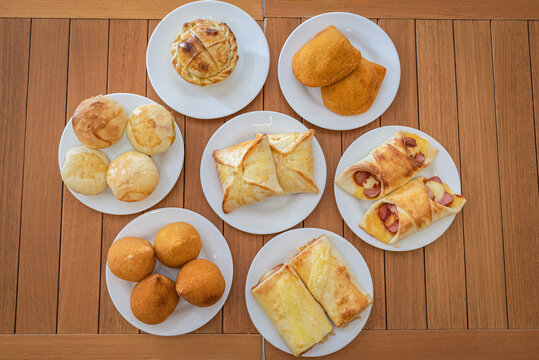 Assortment of Brazilian Savory Snacks on Wooden Table