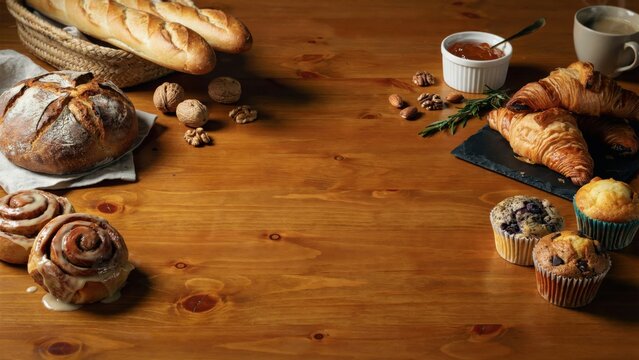 Assorted baked goods on wooden table with nuts and coffee